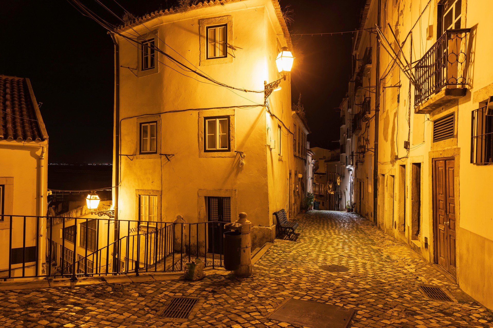 Narrow streets in Alfama district in Lisbon by night